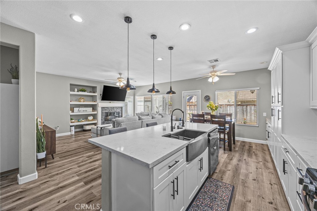 1251 Stepstone Court Hemet, CA 92545 - Photo 9 of 51 a kitchen with stainless steel appliances granite countertop a stove and a wooden floors