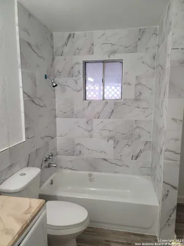 a bathroom with a sink toilet and mirror