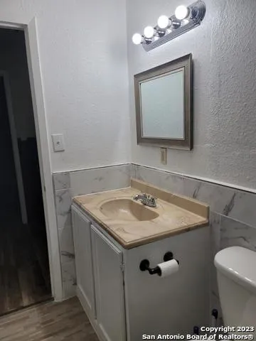 a view of a room with wooden floor