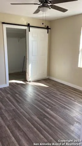 a view of a small space with wooden floor and a window