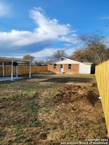 a view of a back yard of the house