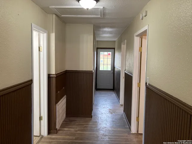 a view of hallway with wooden floor