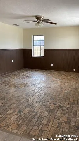 a view of an empty room and a window