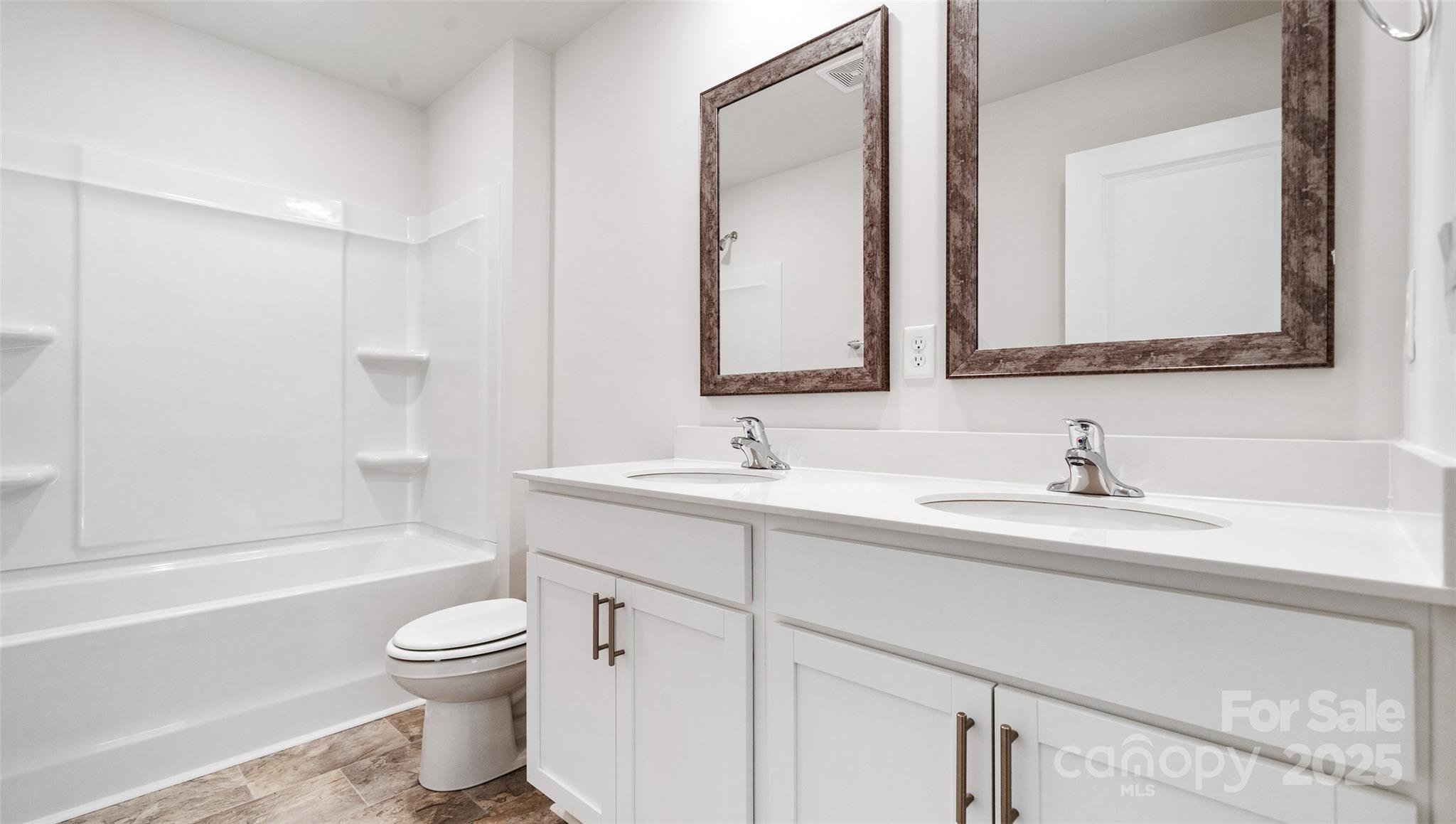 22 Callie River Clyde, NC 28721 - Photo 20 of 23 a bathroom with a toilet a sink a bathtub and a mirror