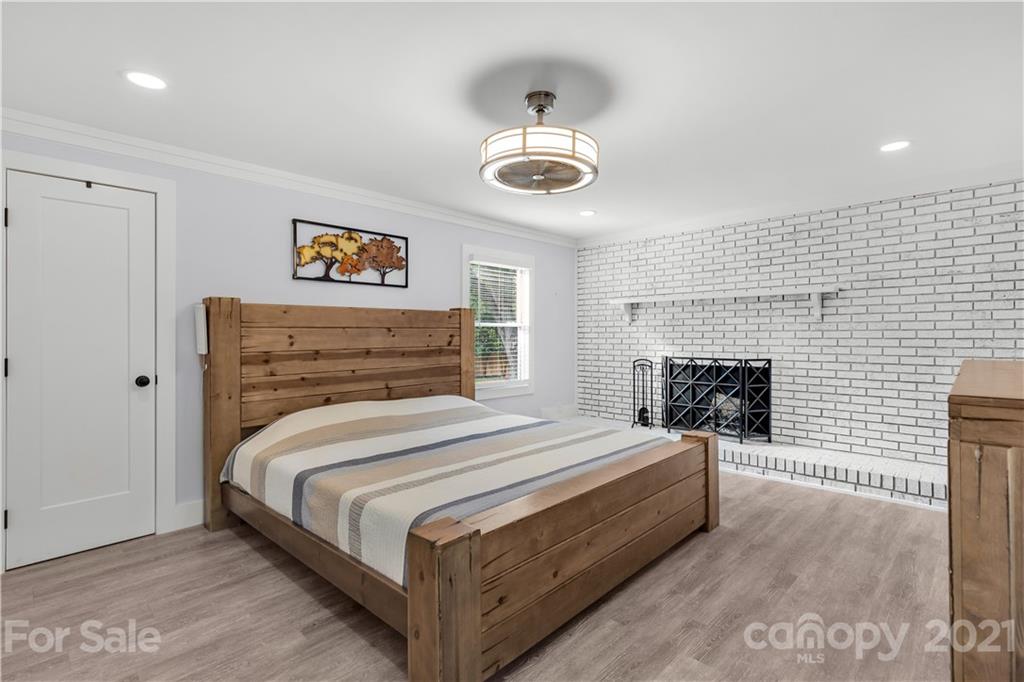 2616 Williams Road Matthews, NC 28105 - Photo 16 of 26 a bedroom with a bed and a fireplace