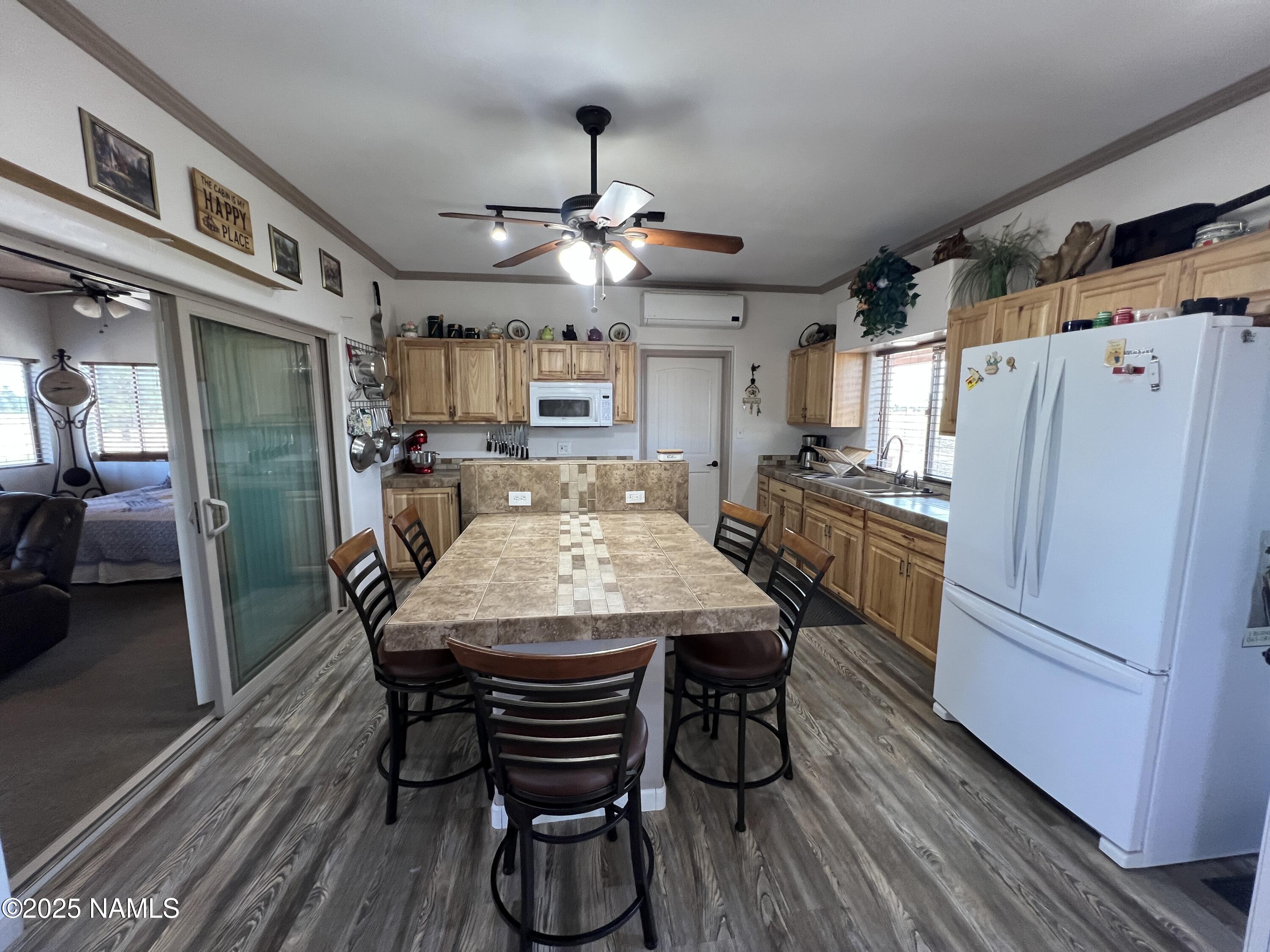 665 Dust Devil Drive Parks, AZ 86005 - Photo 14 of 44 a view of a dining room with furniture a chandelier and wooden floor