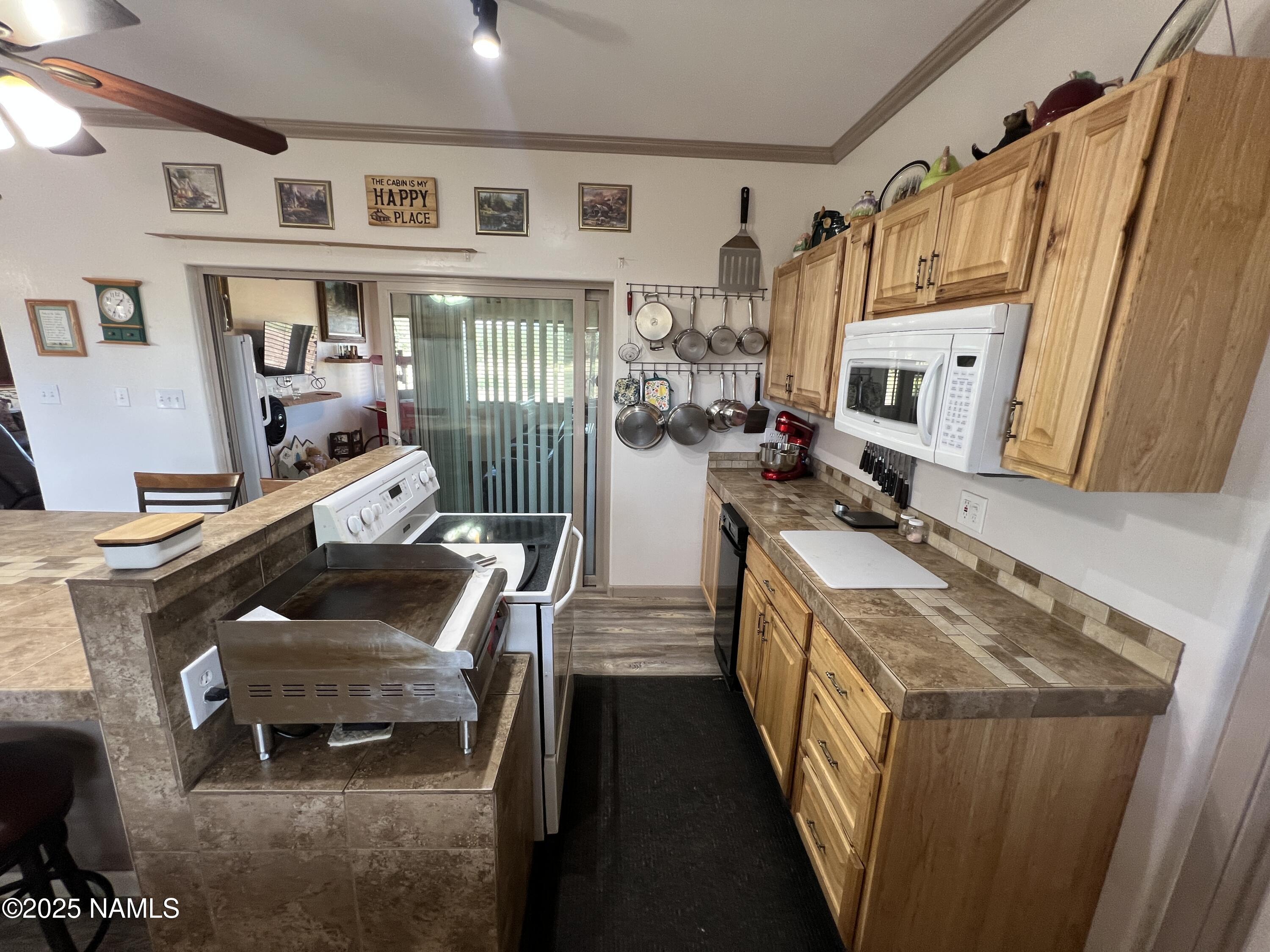 665 Dust Devil Drive Parks, AZ 86005 - Photo 15 of 44 a kitchen with stainless steel appliances granite countertop a stove a sink dishwasher and a refrigerator