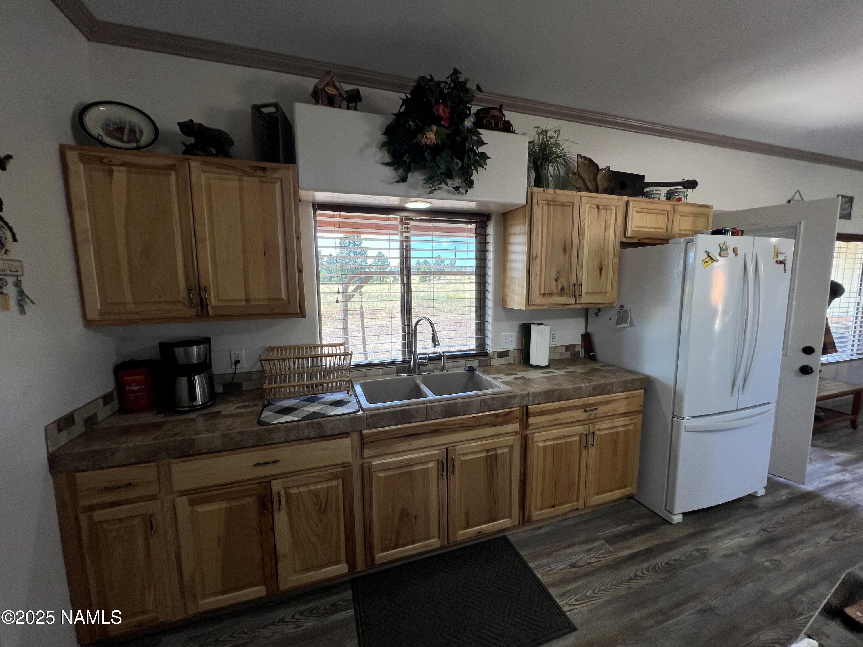 665 Dust Devil Drive Parks, AZ 86005 - Photo 16 of 44 a kitchen with appliances a sink and cabinets