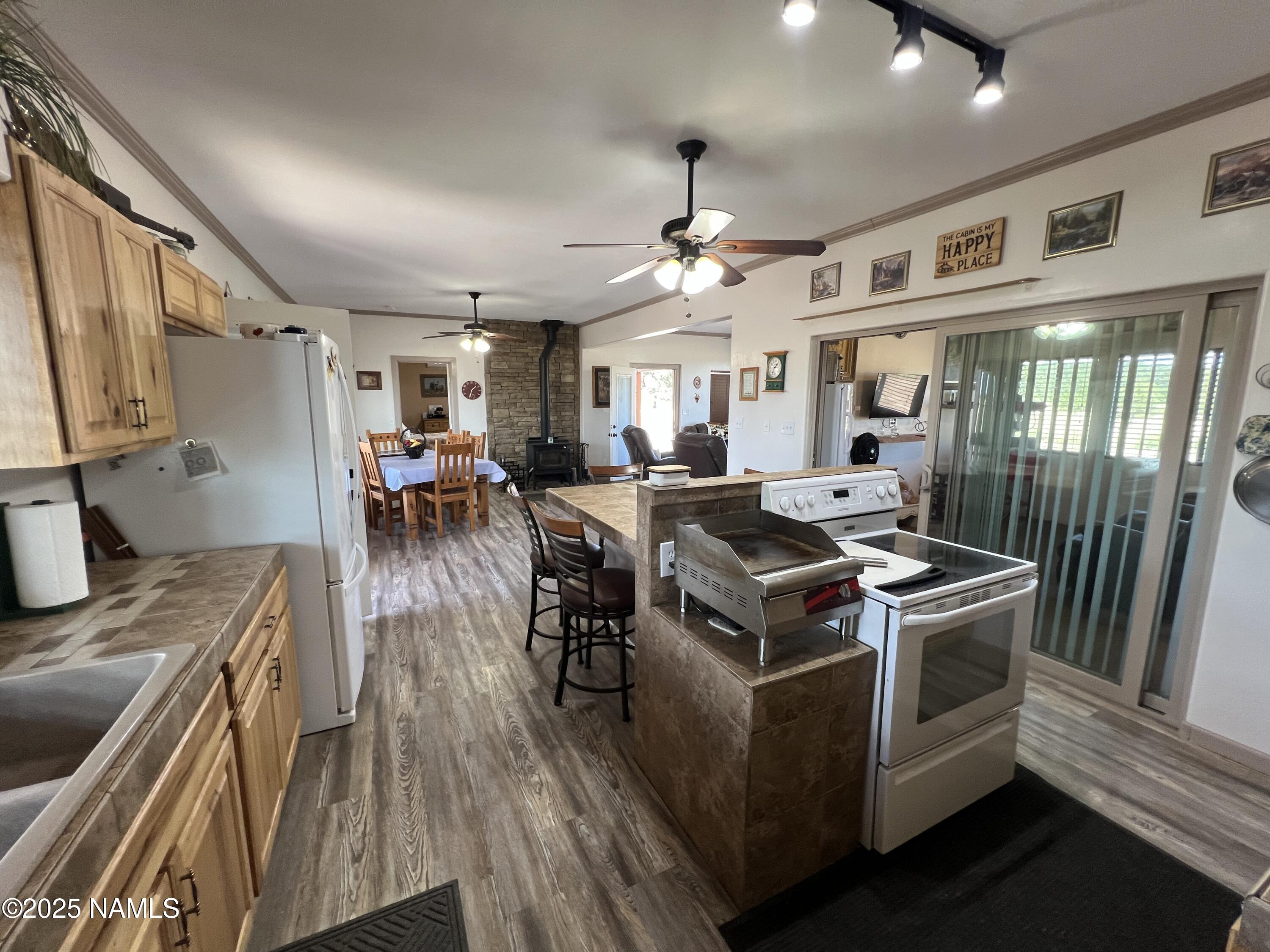 665 Dust Devil Drive Parks, AZ 86005 - Photo 17 of 44 a kitchen with stainless steel appliances granite countertop a stove and a sink