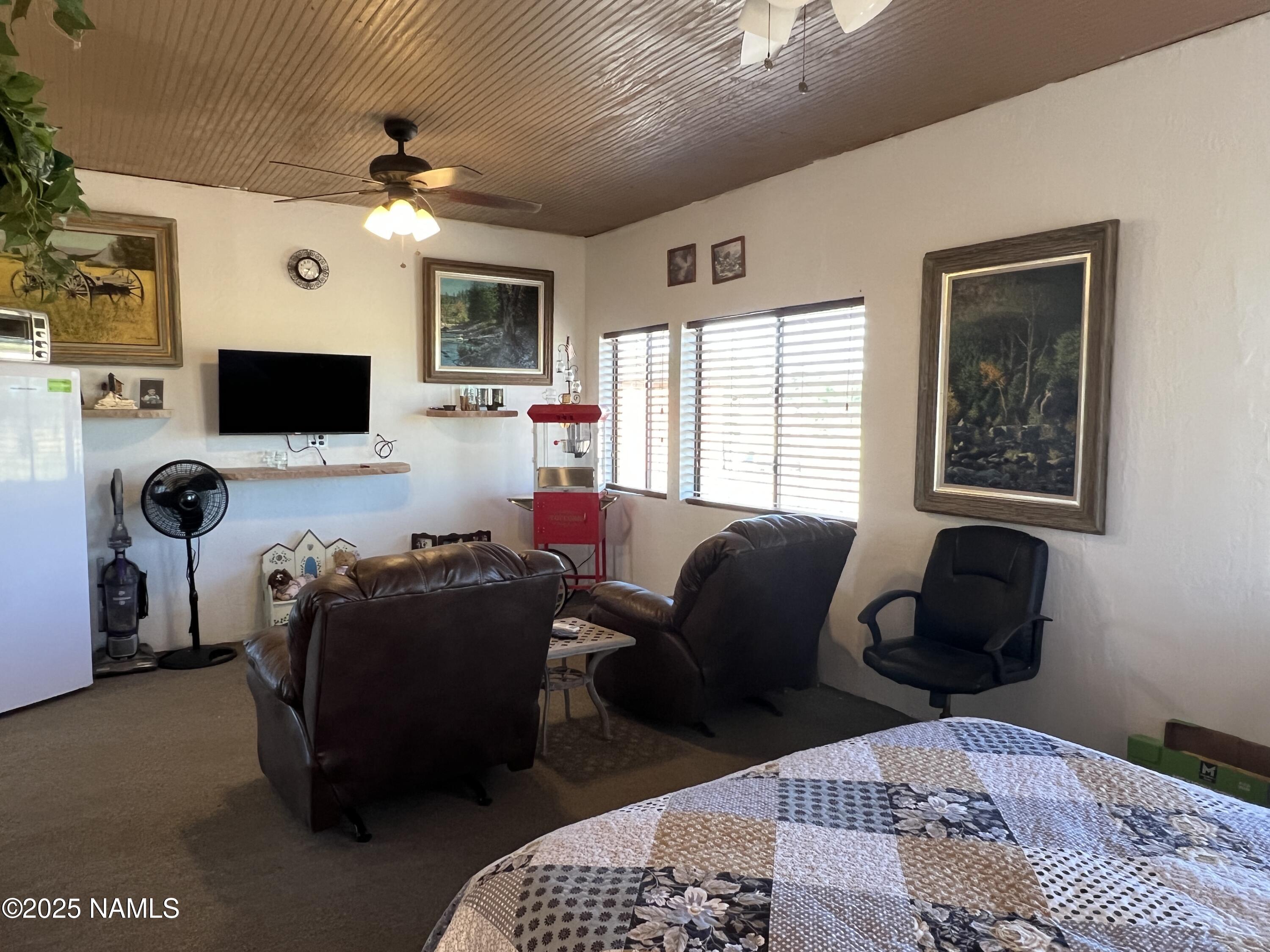665 Dust Devil Drive Parks, AZ 86005 - Photo 18 of 44 a living room with furniture a flat screen tv and a window