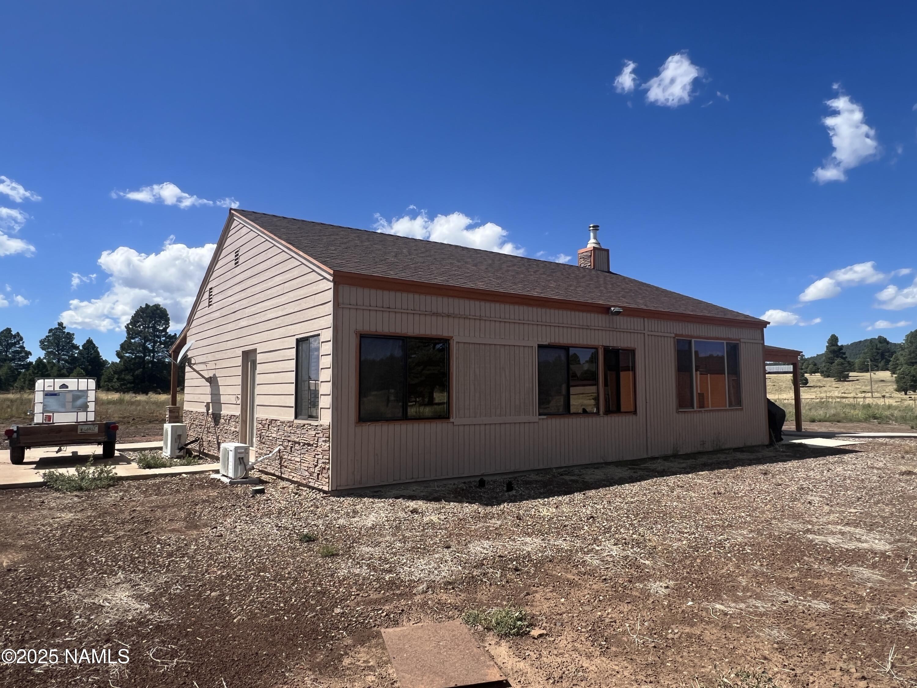 665 Dust Devil Drive Parks, AZ 86005 - Photo 4 of 44 a view of a house with a yard
