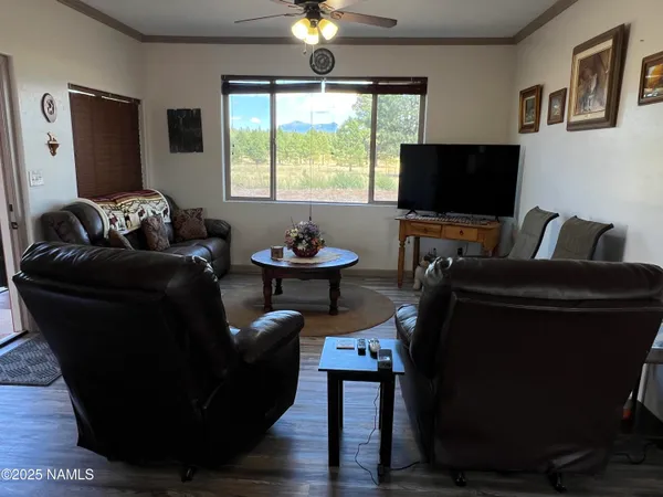 a kitchen with stainless steel appliances granite countertop a stove a sink dishwasher a dining table and chairs with wooden floor