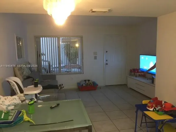 a bed sitting in a bedroom next to a lamp