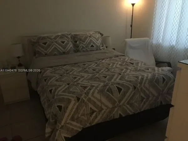 a bathroom with a granite countertop sink a toilet a bathtub and shower