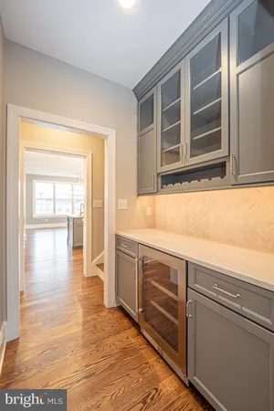 a kitchen that has a lot of cabinets in it and wooden floors