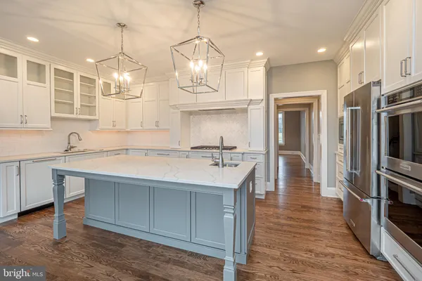 a kitchen with granite countertop a sink stainless steel appliances and cabinets