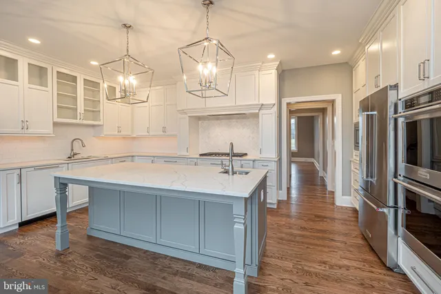 a kitchen with granite countertop a sink stainless steel appliances and cabinets