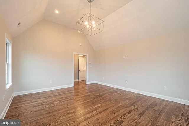 a living room with a large window and chandelier