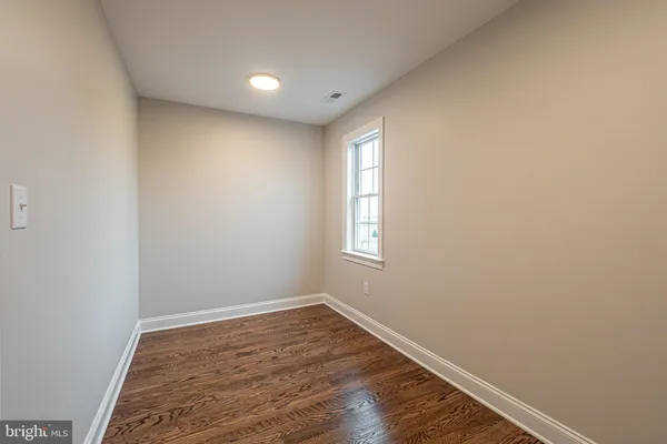 a white bath tub sitting in a bathroom next to a window