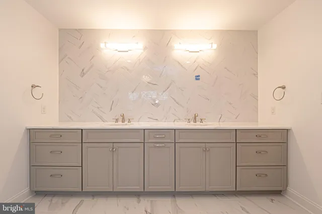 a view of an empty room with wooden floor and window