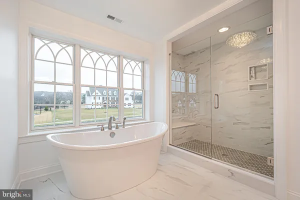 a bathroom with a granite countertop sink a toilet and bathtub