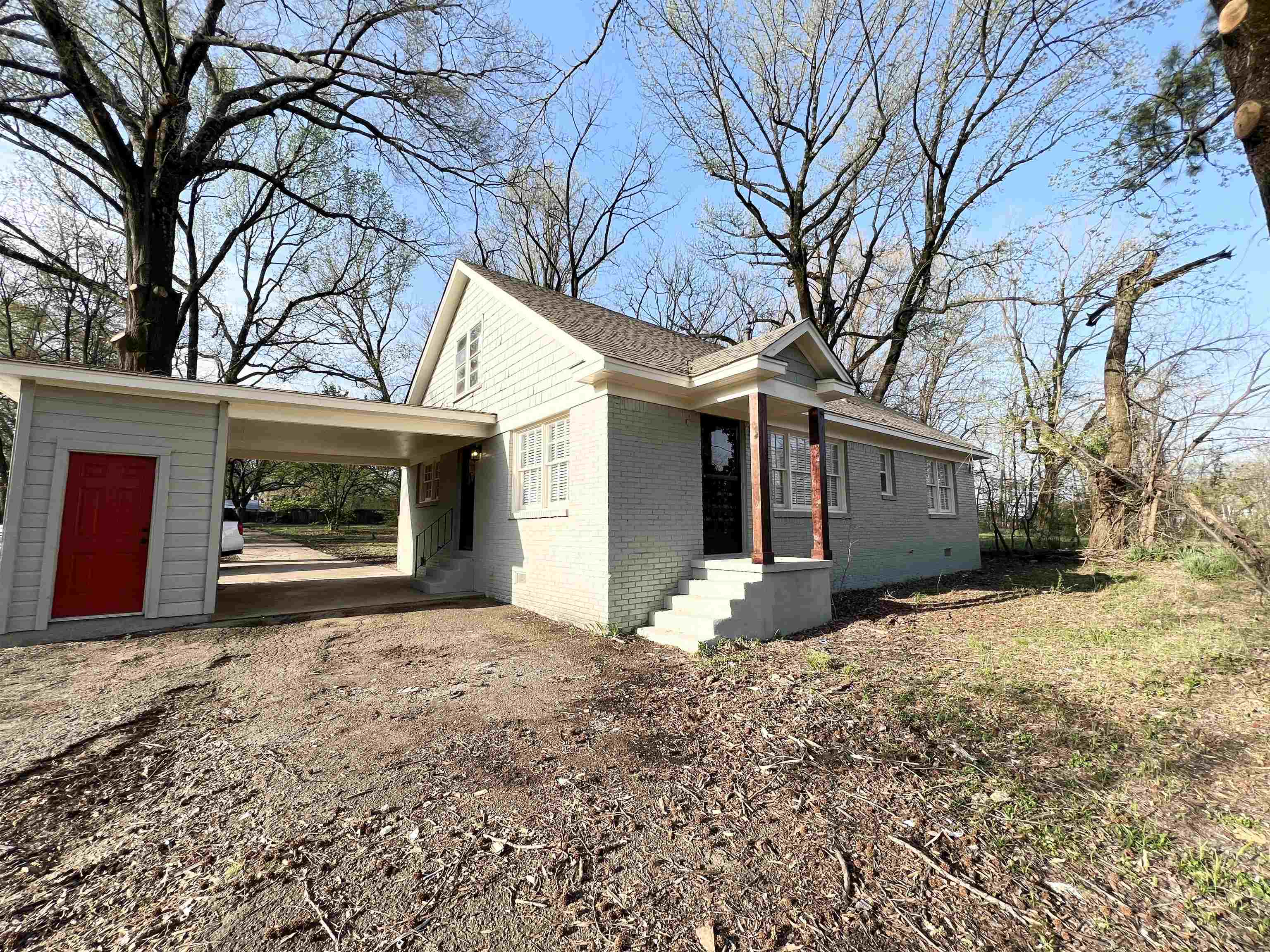 105 West Peebles Road Memphis, TN 38109 - Photo 1 of 15 a front view of a house with a yard and garage