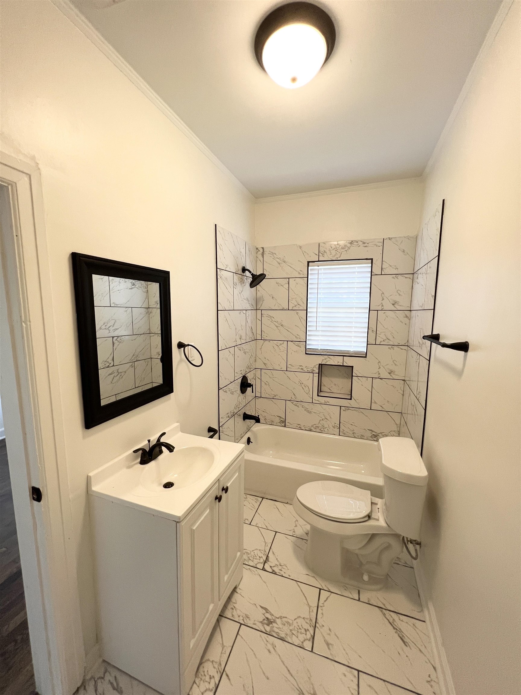 105 West Peebles Road Memphis, TN 38109 - Photo 11 of 15 a bathroom with a sink mirror bathtub and toilet