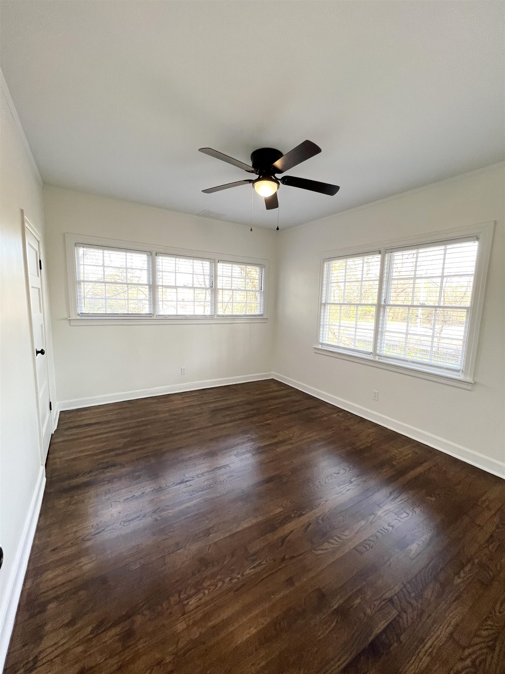 105 West Peebles Road Memphis, TN 38109 - Photo 12 of 15 an empty room with wooden floor and windows