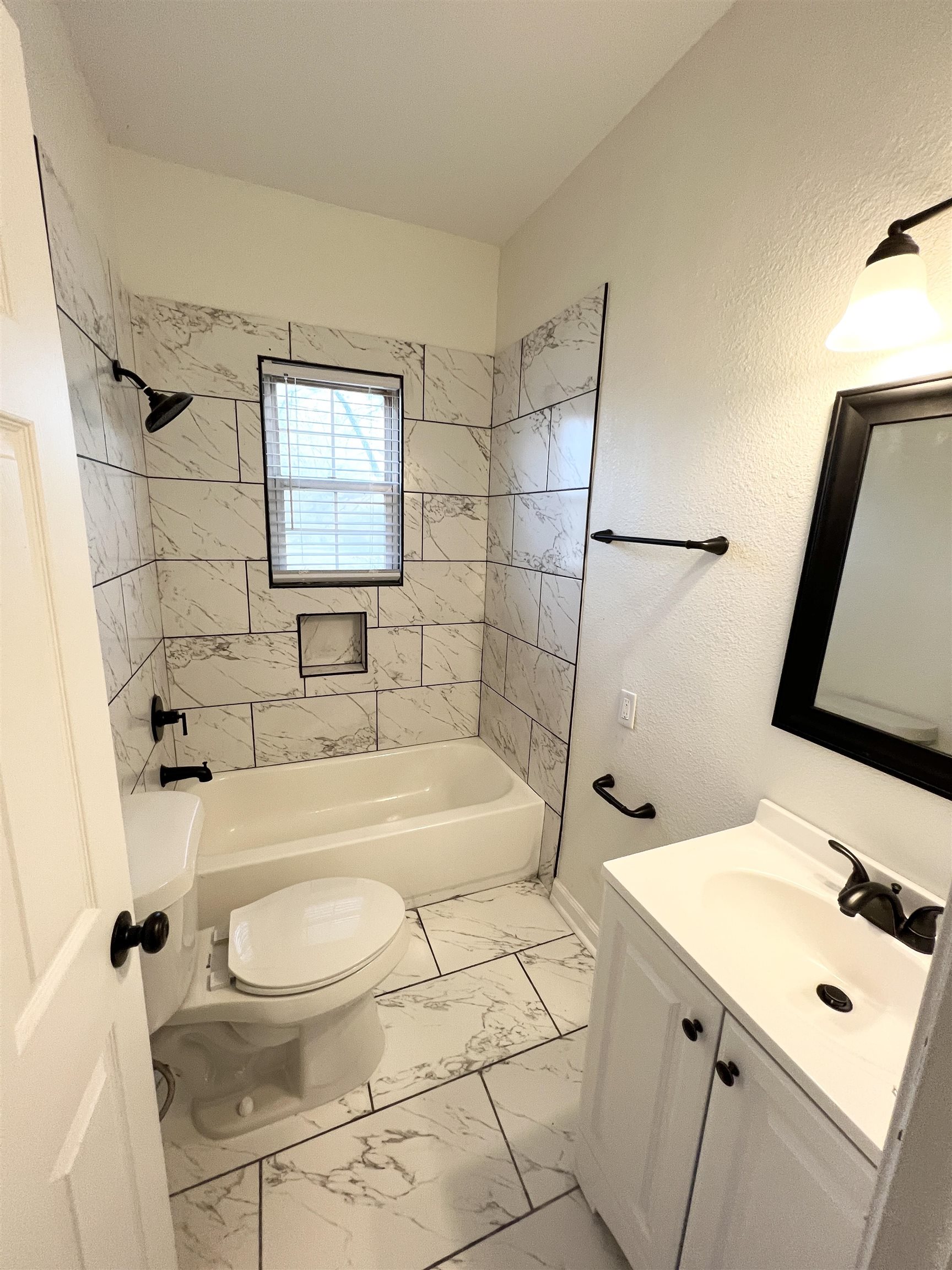 105 West Peebles Road Memphis, TN 38109 - Photo 14 of 15 a bathroom with a sink a toilet and shower