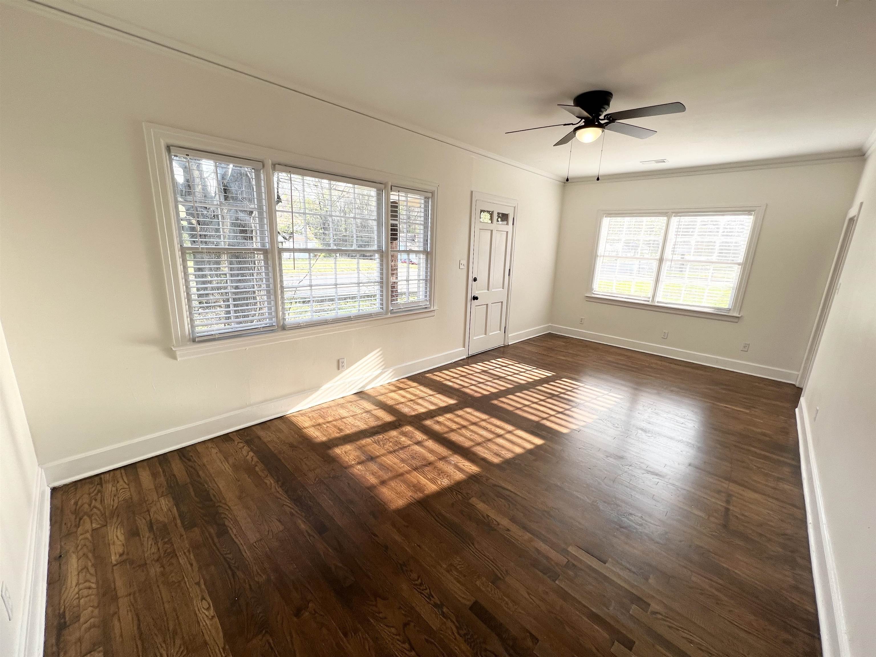 105 West Peebles Road Memphis, TN 38109 - Photo 2 of 15 a view of an empty room with wooden floor and a window