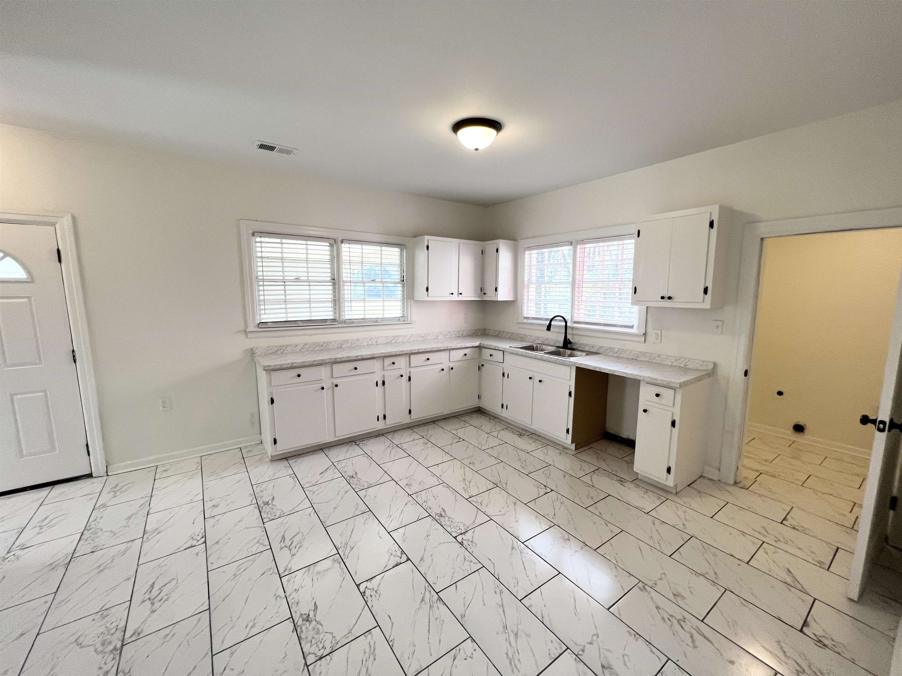 105 West Peebles Road Memphis, TN 38109 - Photo 4 of 15 a large white kitchen with a stove a sink dishwasher and a refrigerator
