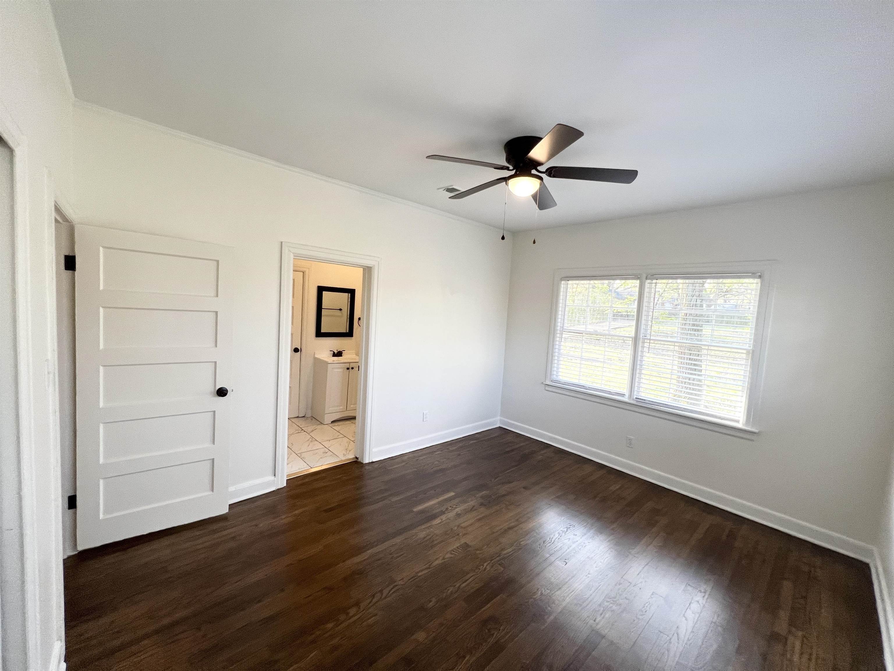 105 West Peebles Road Memphis, TN 38109 - Photo 10 of 15 wooden floor in an empty room with a window