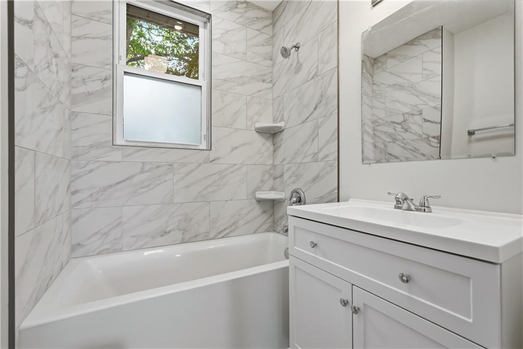 480 Songo Street Pittsburgh, PA 15227 - Photo 20 of 36 a bathroom with a granite countertop sink a toilet and a bathtub