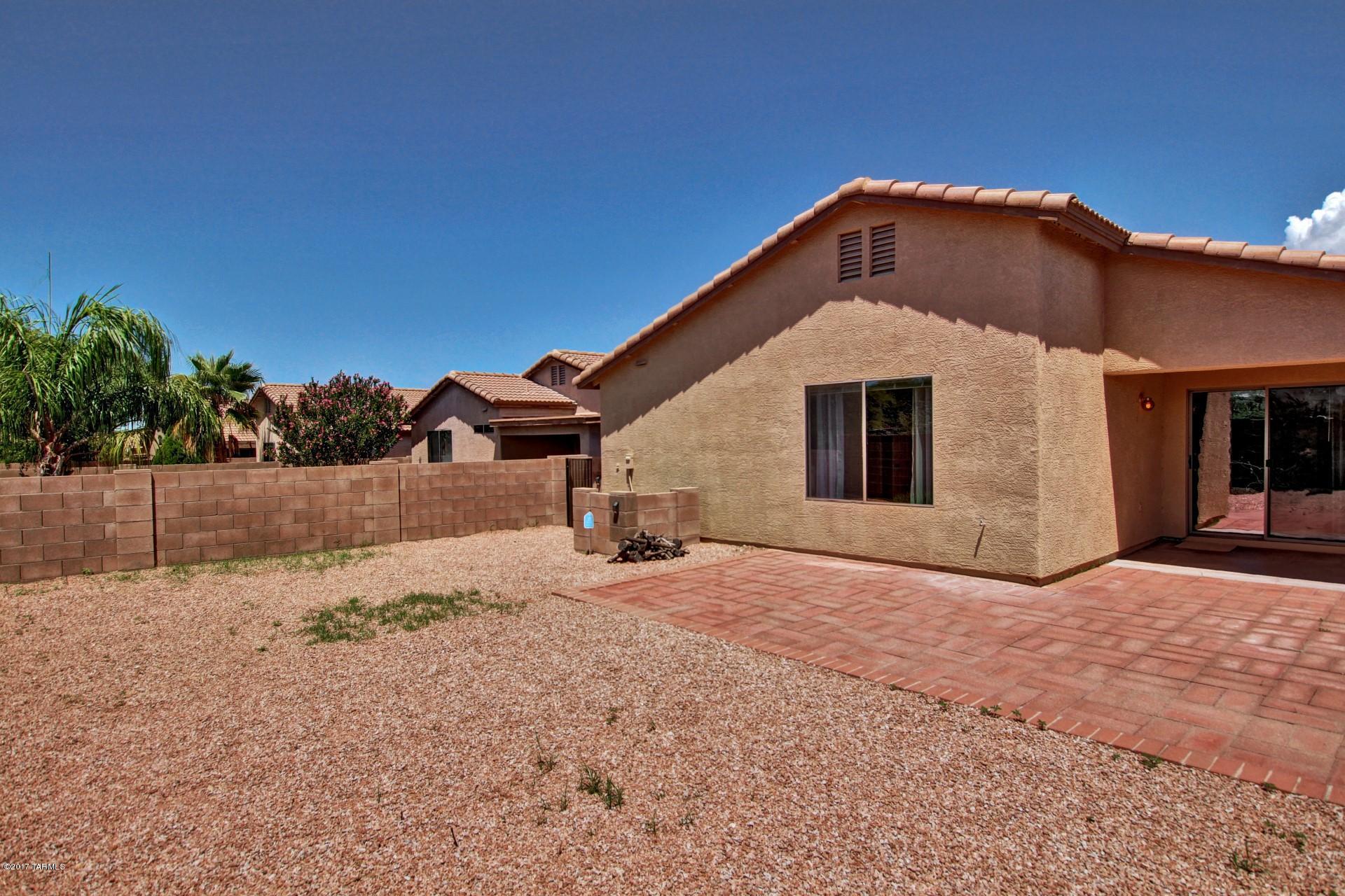 8350 East Bowline Road Tucson, AZ 85710 - Photo 24 of 26 a front view of a house with a yard