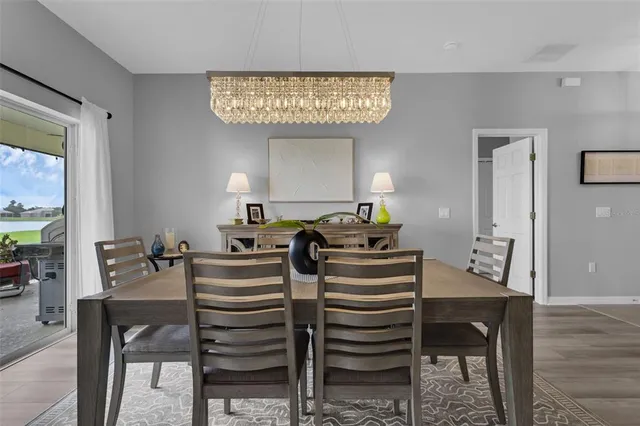 a kitchen with stainless steel appliances kitchen island granite countertop a sink and a refrigerator