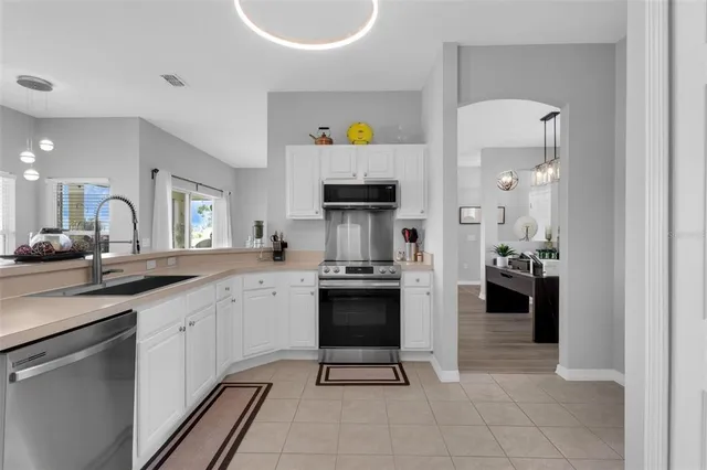 a kitchen with a sink cabinets and stainless steel appliances