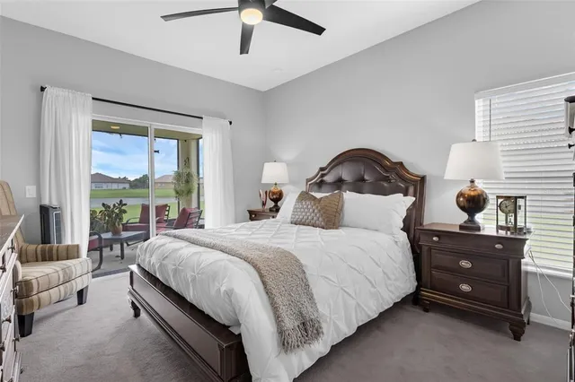 a large bed sitting in a bedroom next to a window with dresser