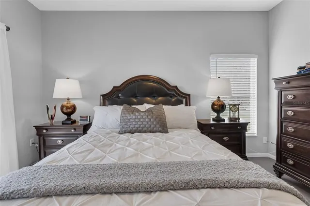 a bedroom with a bed and a night stand