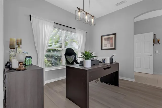 an aerial view of residential houses with outdoor space and trees
