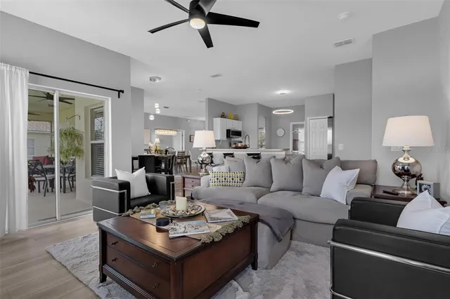 a living room with furniture a rug and a window