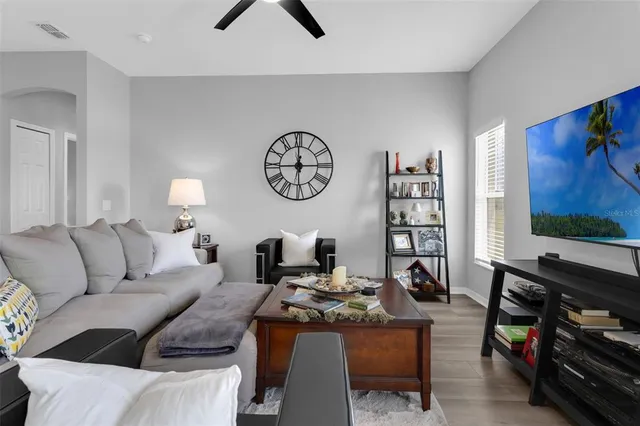 a living room with furniture a dining table and a fireplace