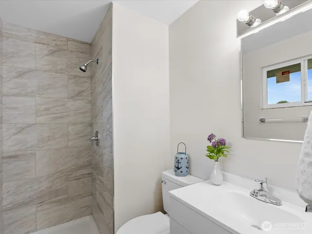 a bathroom with a sink toilet and shower