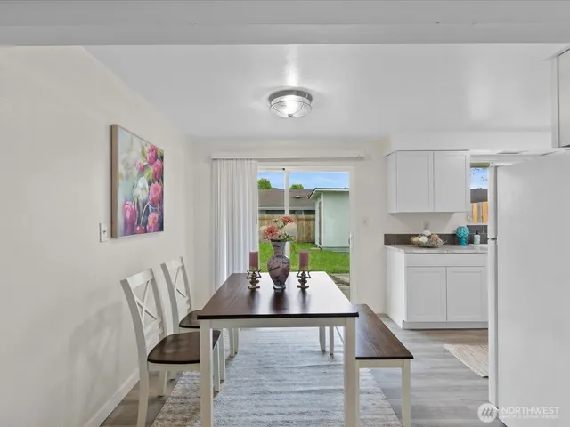 a living room with furniture a window and kitchen view