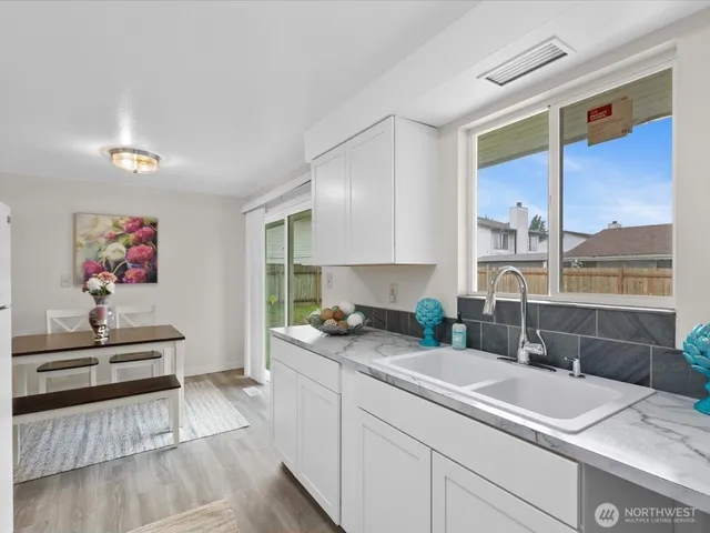 a kitchen with a sink and a stove top oven