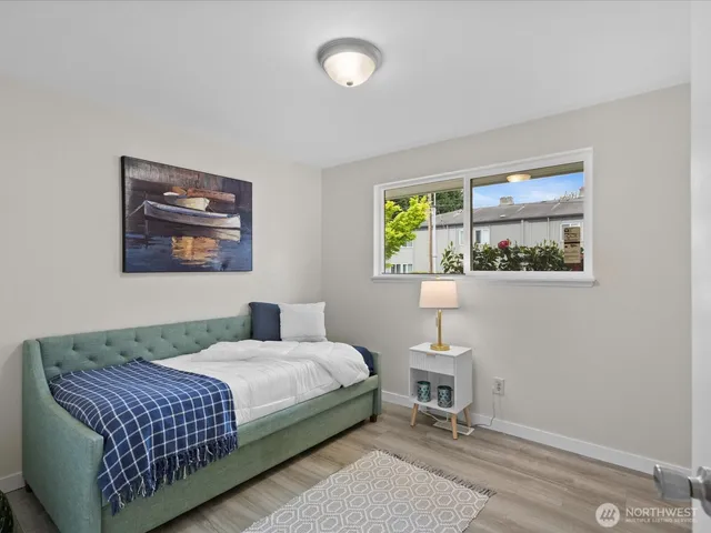 a bedroom with a bed and a painting on the wall