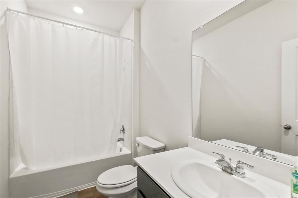 755 Amelia Court Pilot Point, TX 76258 - Photo 16 of 28 a bathroom with a sink toilet and a mirror