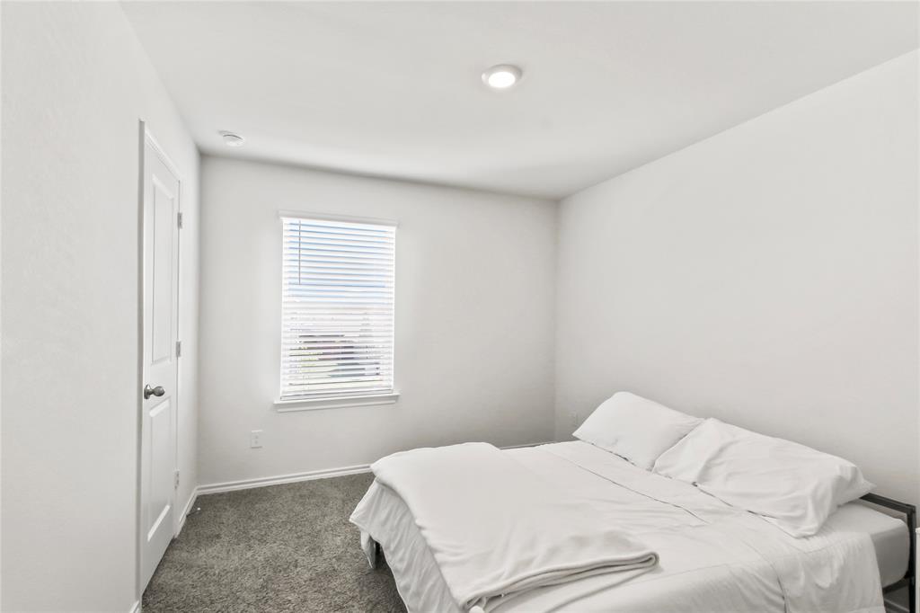 755 Amelia Court Pilot Point, TX 76258 - Photo 20 of 28 a bedroom with a bed and a window