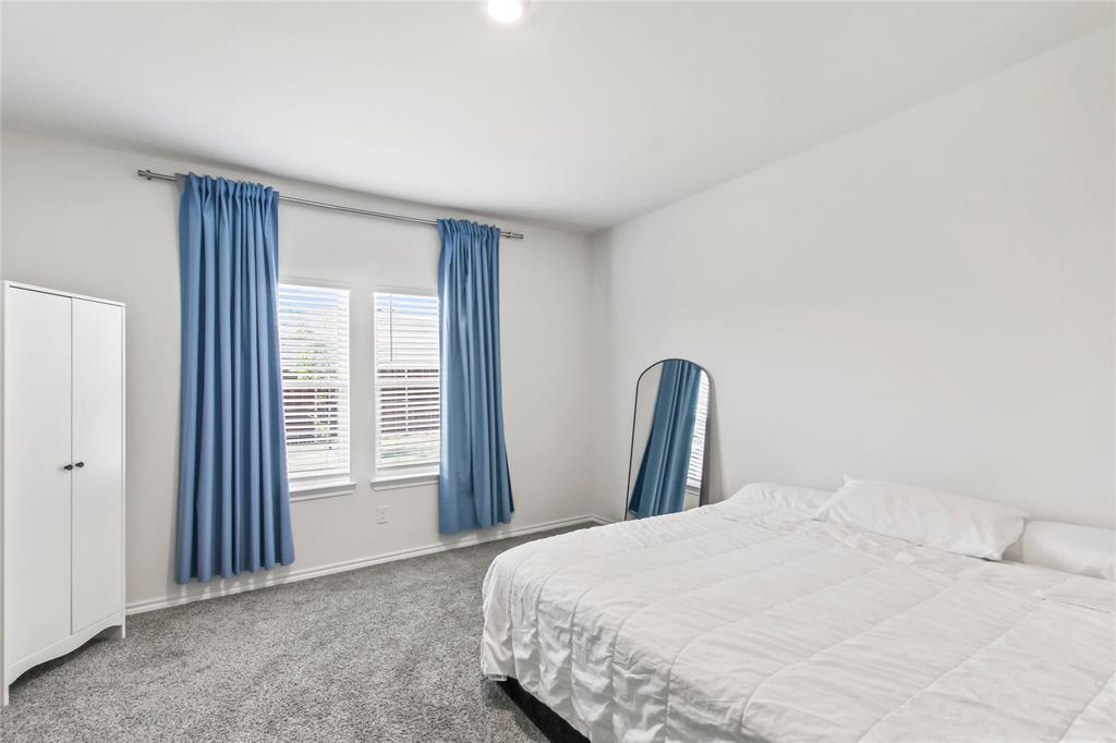 755 Amelia Court Pilot Point, TX 76258 - Photo 21 of 28 a bedroom with a bed and a window