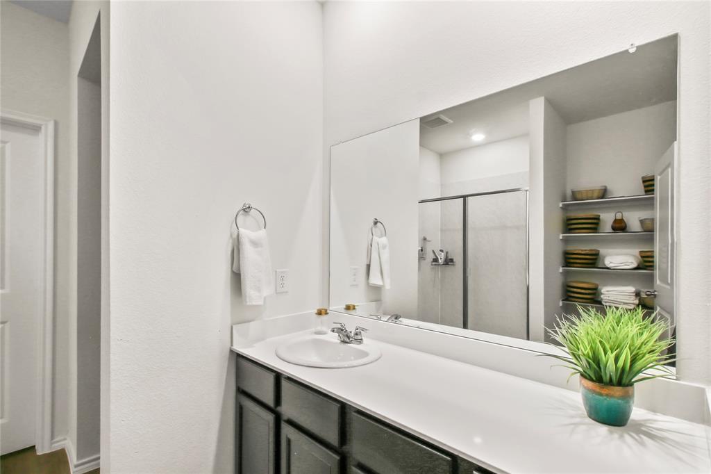 755 Amelia Court Pilot Point, TX 76258 - Photo 24 of 28 a bathroom with a sink and a mirror