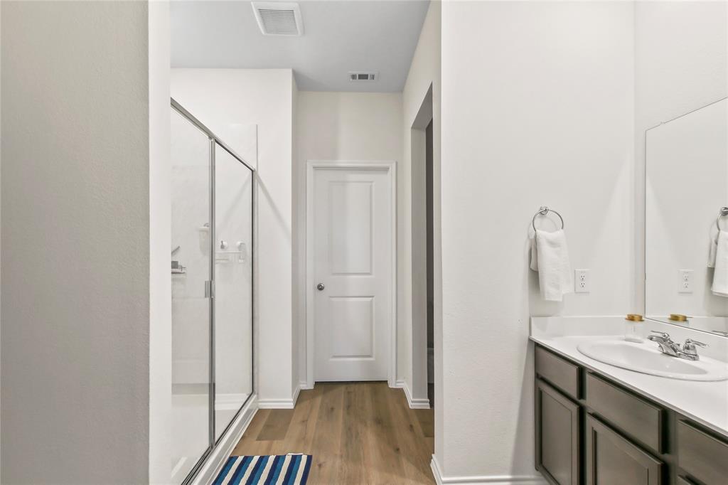 755 Amelia Court Pilot Point, TX 76258 - Photo 25 of 28 a bathroom with a sink and a mirror